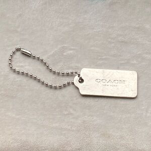 Coach New York small silver metal logo tag